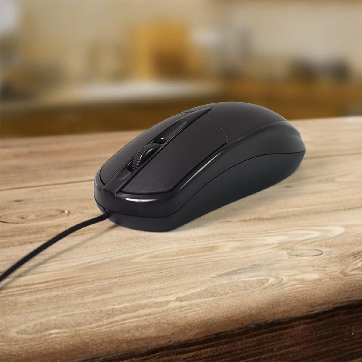 A close-up of a black wired mouse with a scroll wheel, resting on a light wooden surface.