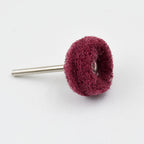 A single maroon buffing wheel with a silver shaft on a white background.