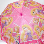 Close-up of the pink umbrella canopy showing multiple Disney Princess characters and text.