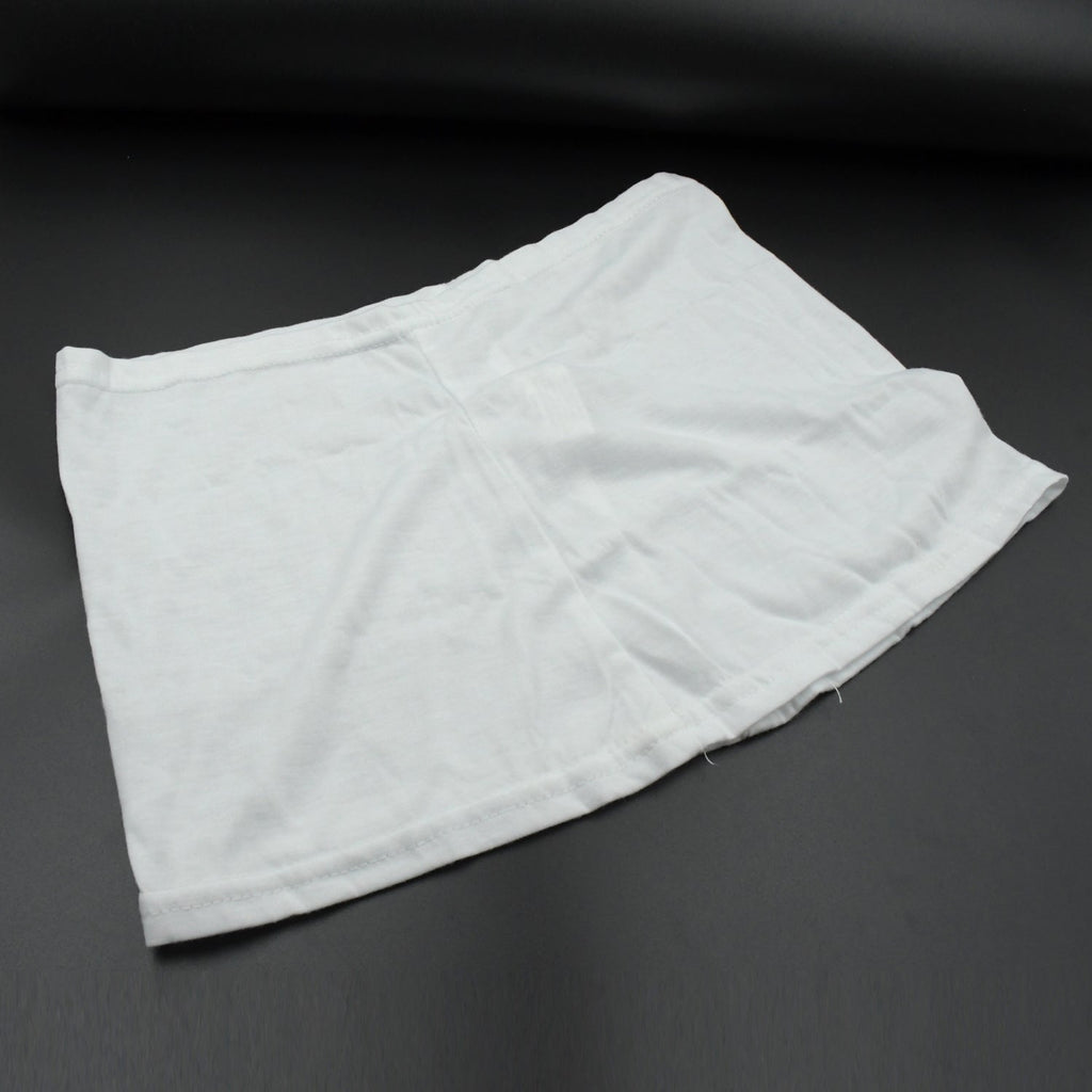 A white layered hip skirt with shorts lies folded on a dark gray surface.