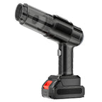 Black handheld vacuum cleaner with a clear dustbin and red battery pack, standing upright on a white background.