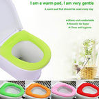 A green soft fabric toilet seat cover on a white toilet with text highlighting its warmth and comfort benefits.