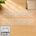 Ten clear self-adhesive wall hooks arranged on a light wood surface, with an inset showing string lights hung by similar