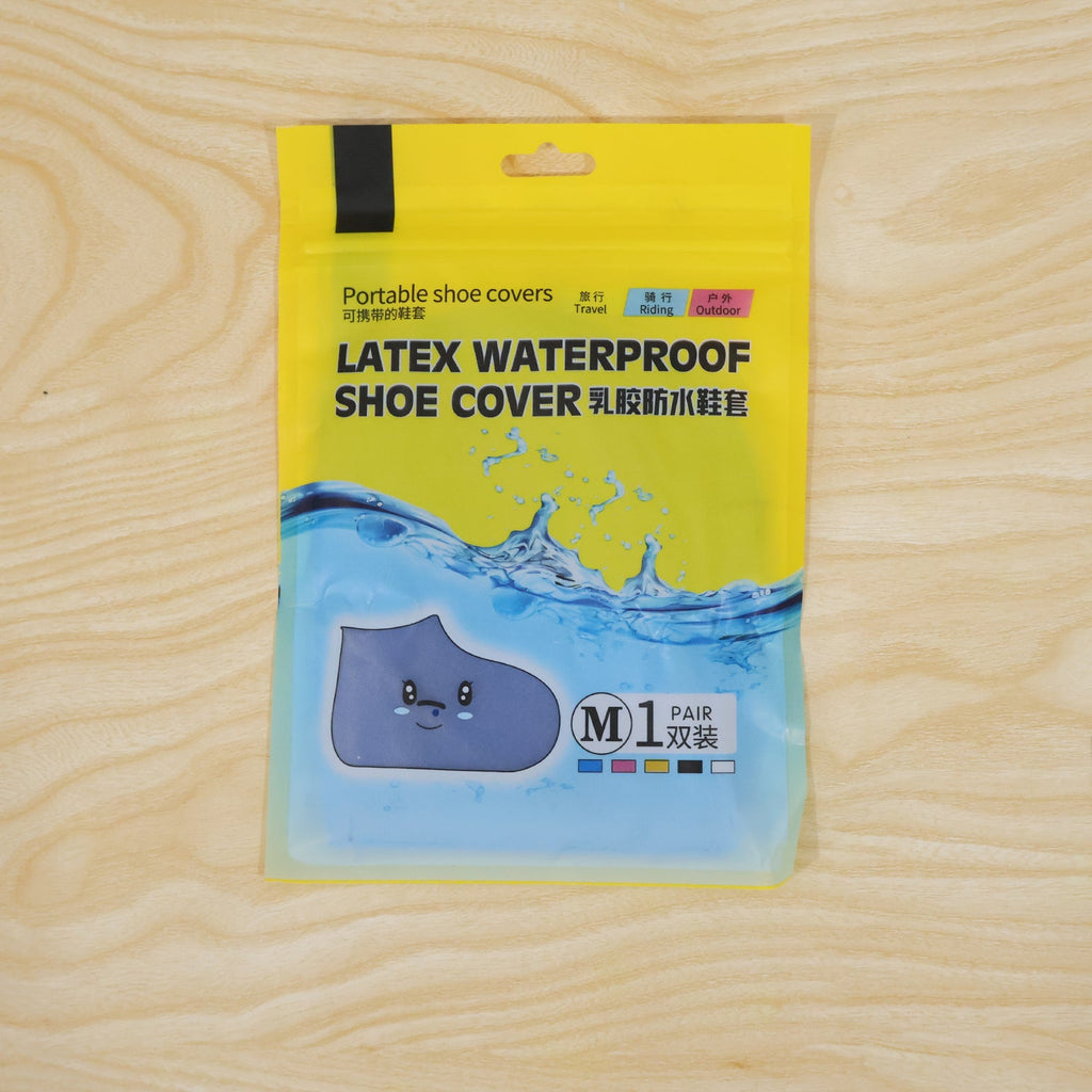 A yellow and blue package for "LATEX WATERPROOF SHOE COVER" with a cartoon shoe is on a wooden surface.