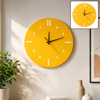 A bright yellow round wall clock with white hour markers and black hands hangs on a light wall. A smaller inset shows a