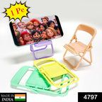 A phone displaying animated characters rests on a purple chair stand, with peach, yellow, and green chairs nearby.