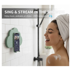 A woman sings in the shower next to a teal cloud-shaped phone holder on a white tiled wall.