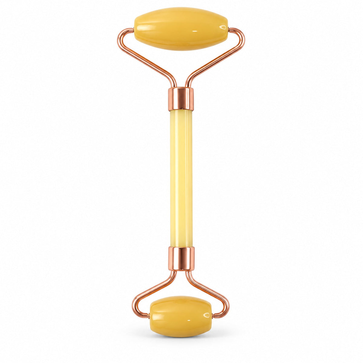 A yellow jade facial roller with rose gold colored metal accents is centered on a plain white background.