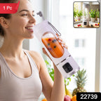 A smiling woman in a light sports bra sips from a white portable blender filled with orange juice and berries.