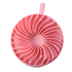 A pink silicone body scrubber with a spiral pattern of bristles and a hanging loop is shown on a white background.