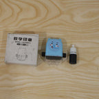 A blue elephant math roller stamp, a black ink bottle, and a white box with Chinese text and a stamp illustration are on a