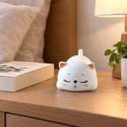 Sleeping cat night light illuminated with warm glow
