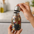 Hands holding the golden stainless steel vacuum bottle with a peacock print, unscrewing its silver lid.