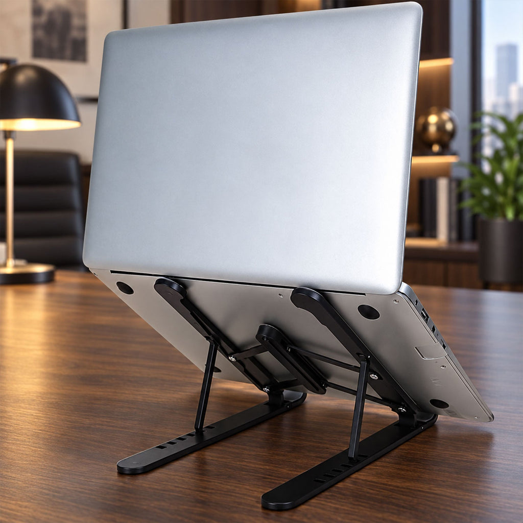 A silver laptop is displayed on a black adjustable stand, angled upwards on a wooden desk in an office setting.