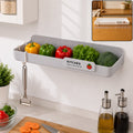 Wall mounted plastic kitchen drain rack holding vegetables
