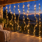 Golden leaf curtain string lights on a balcony