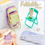 A stack of folded pastel chairs next to a teal chair holding a cat figurine, with a phone and text overlay.