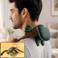 A man with dark hair wears a green bionic neck massager with a brown strap, smiling slightly. Inset shows the massager on a