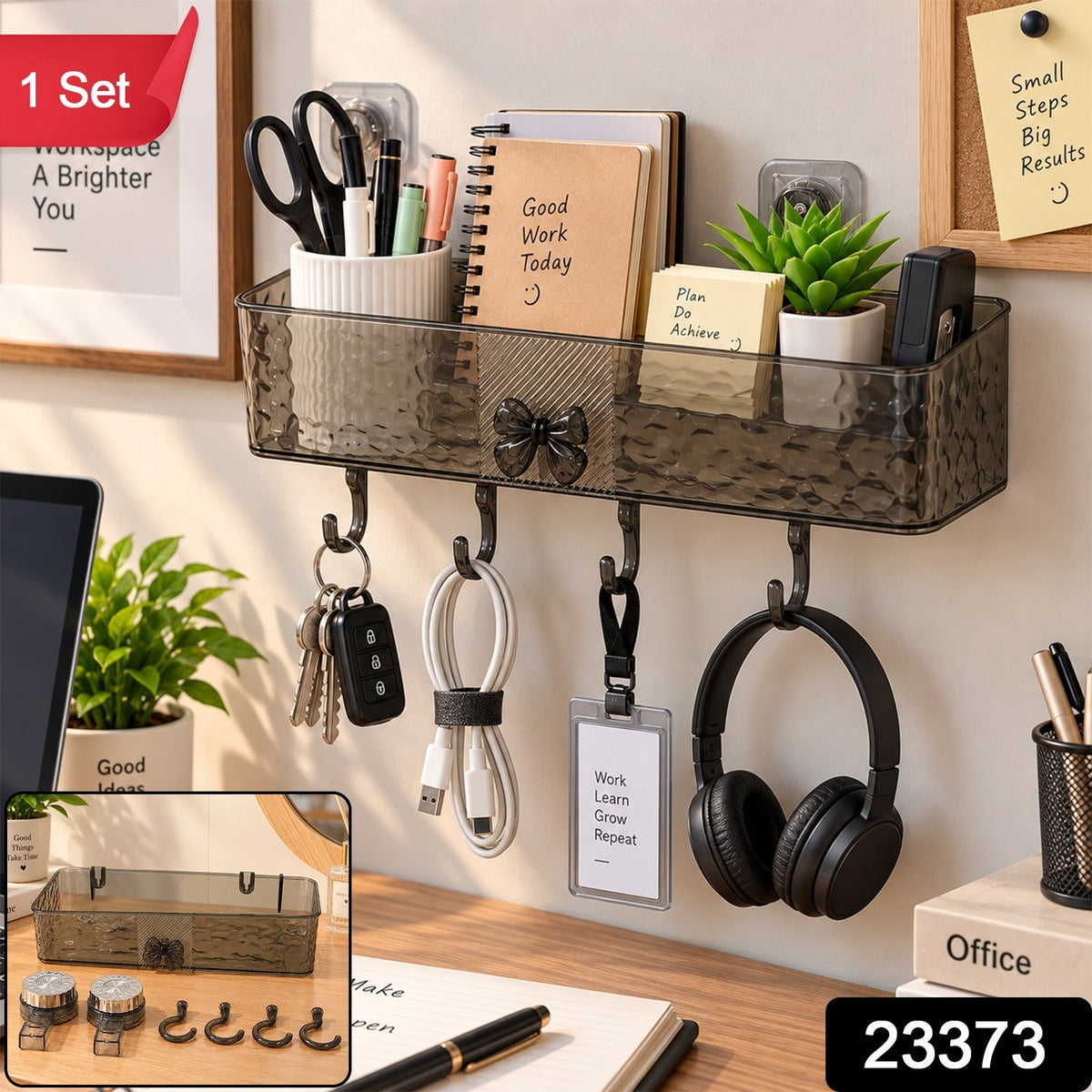 A dark gray plastic wall-mounted storage shelf with four hooks, holding office supplies, keys, and headphones, with a red "1
