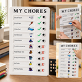 White 'MY CHORES' checklist board with green checkmarks and red X's on a wooden desk with books and a plant.