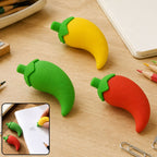 Three chili pepper erasers in red, yellow, and green, with a small inset showing a hand using a yellow eraser on paper.