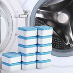 Stacks of blue and white washing machine cleaner tablets in front of a washing machine drum.