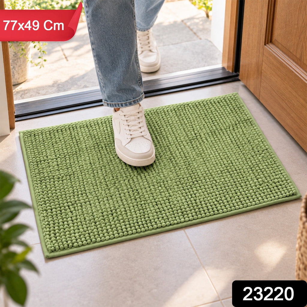 A person's feet in white sneakers stepping onto a green bobble mat, with product dimensions and code overlaid.