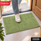 A person's feet in white sneakers stepping onto a green bobble mat, with product dimensions and code overlaid.