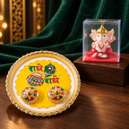 A gold-rimmed white and yellow pooja thali with Radhe Radhe text and two small containers sits on a wooden surface beside a