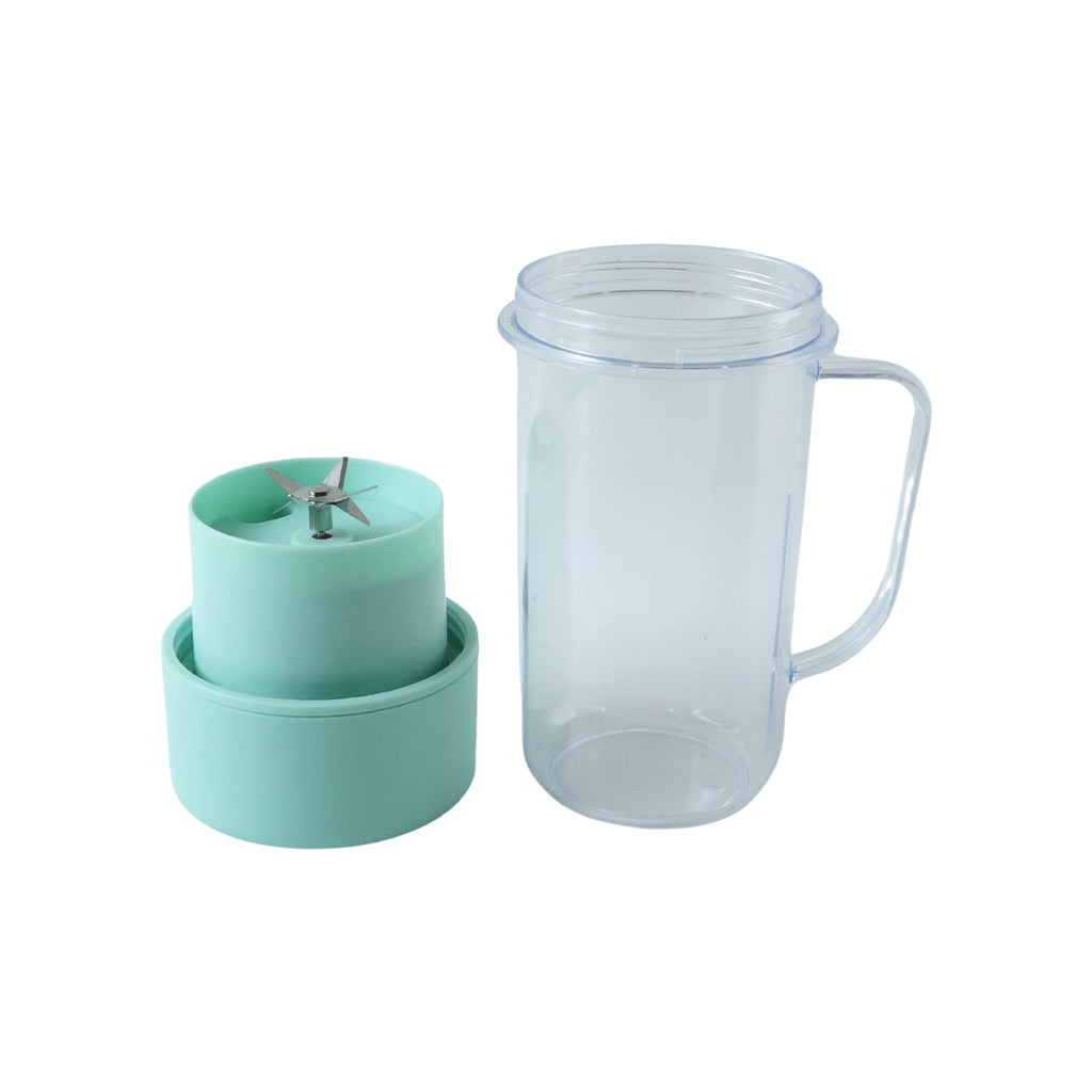 The clear blender bottle stands next to its disassembled mint green base, revealing a four-blade stainless steel blender.