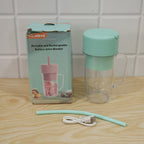 A mint green blender bottle, a matching straw, and a white USB cable are displayed next to its product box on a wooden