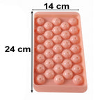 A pink plastic ice ball tray with dimensions 24 cm by 14 cm marked on a white background.