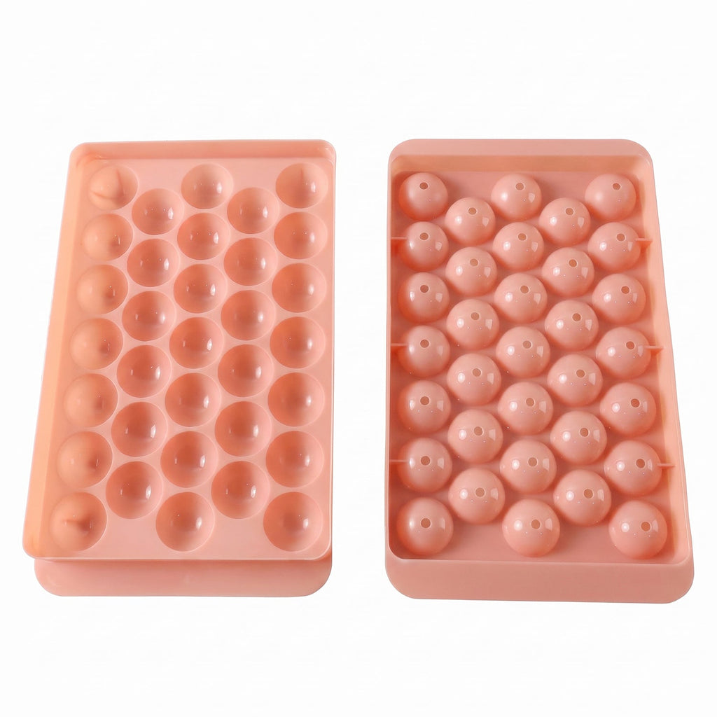 Two pink plastic ice ball trays, one with open spherical molds and the other with covered molds.
