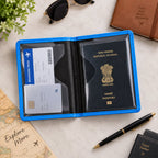 Open blue passport holder with a passport, boarding pass, and card inside on a light wooden table.