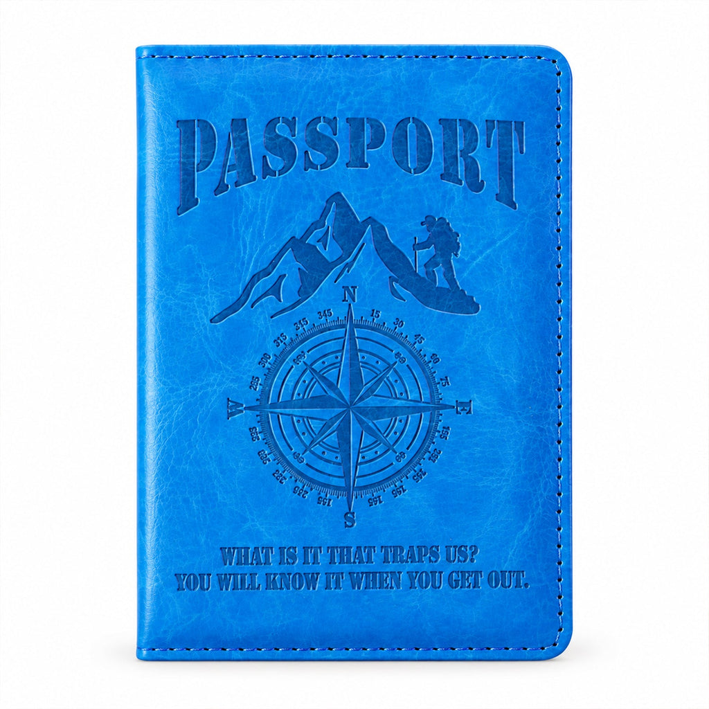 Front view of the closed blue passport holder with an embossed mountain, compass, and text design.