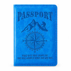 Front view of the closed blue passport holder with an embossed mountain, compass, and text design.
