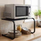 Microwave stand with utensils stored on the lower shelf