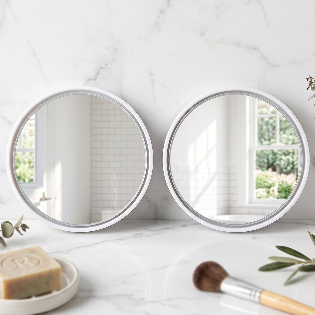 Two round white-framed mirrors on a white marble counter with soap and a makeup brush.
