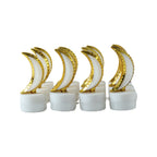 Eight golden crescent moon LED tealights on a white background, unlit and in two rows.