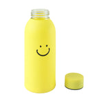 A yellow glass water bottle with a smiley face and its cap are shown on a white background.