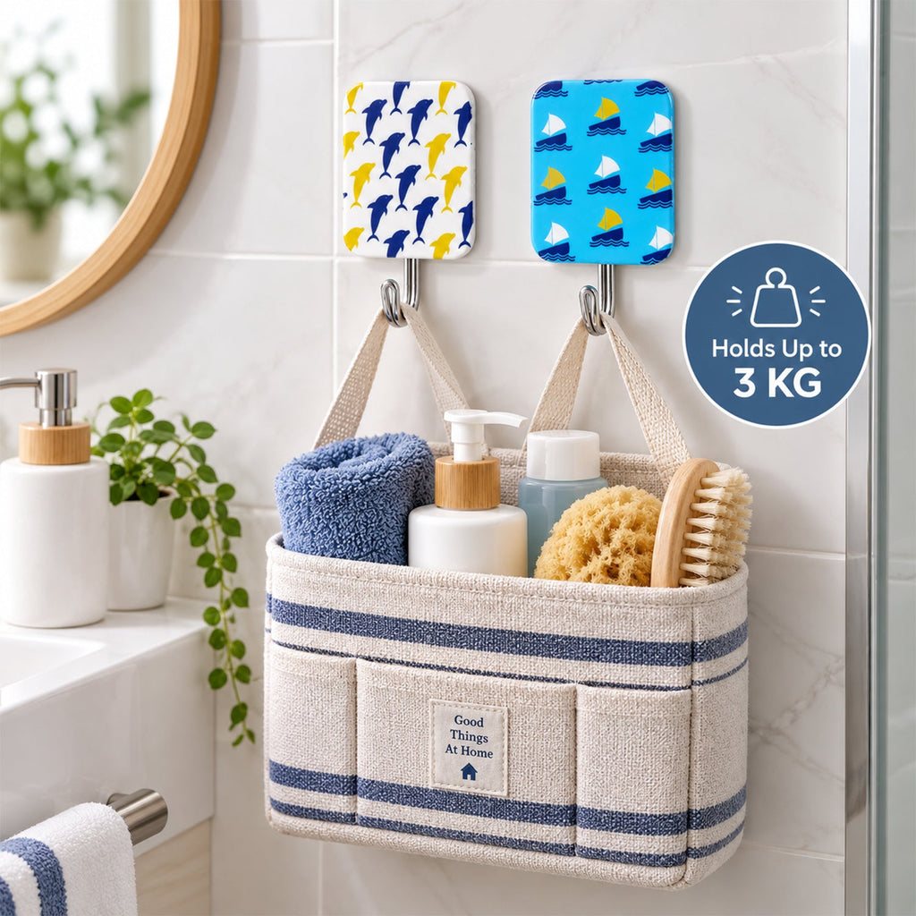 Two decorative hooks on a tiled bathroom wall, supporting a striped fabric caddy filled with toiletries.