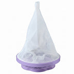 A single purple and white floating lint mesh bag on a white background.