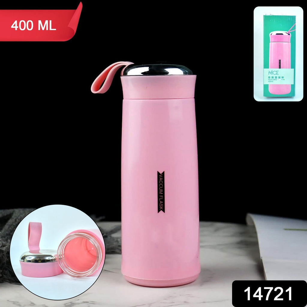 A pink vacuum flask with its lid and glass interior separated, next to its packaging on a black background.