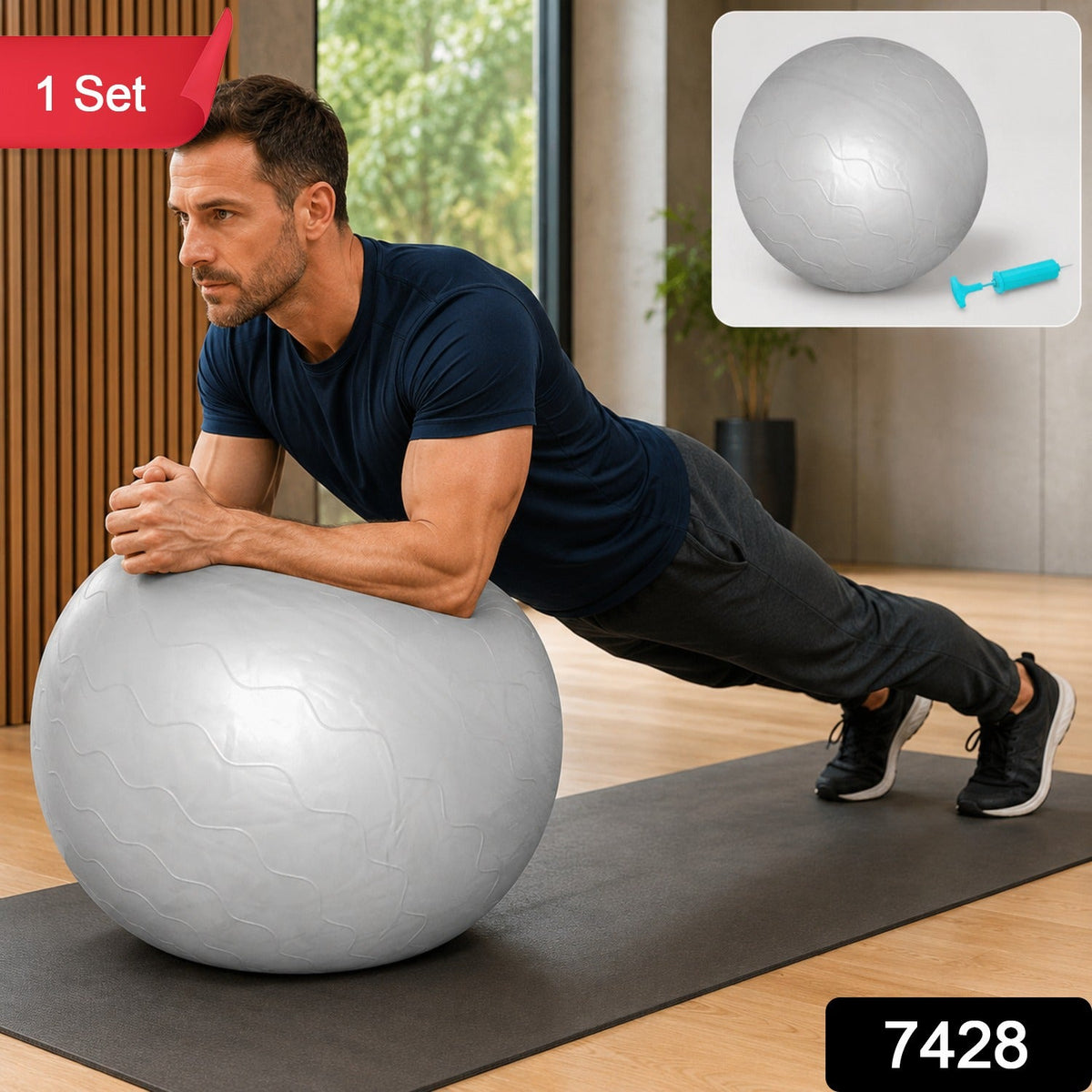 A man in a navy t-shirt and dark pants holds a plank position with his forearms on a grey stability ball. A small – view 2