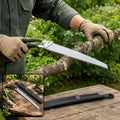 A person wearing tan gloves saws a tree branch with a silver and black pruning saw, with an inset showing the saw and its