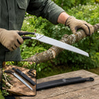 A person wearing tan gloves saws a tree branch with a silver and black pruning saw, with an inset showing the saw and its
