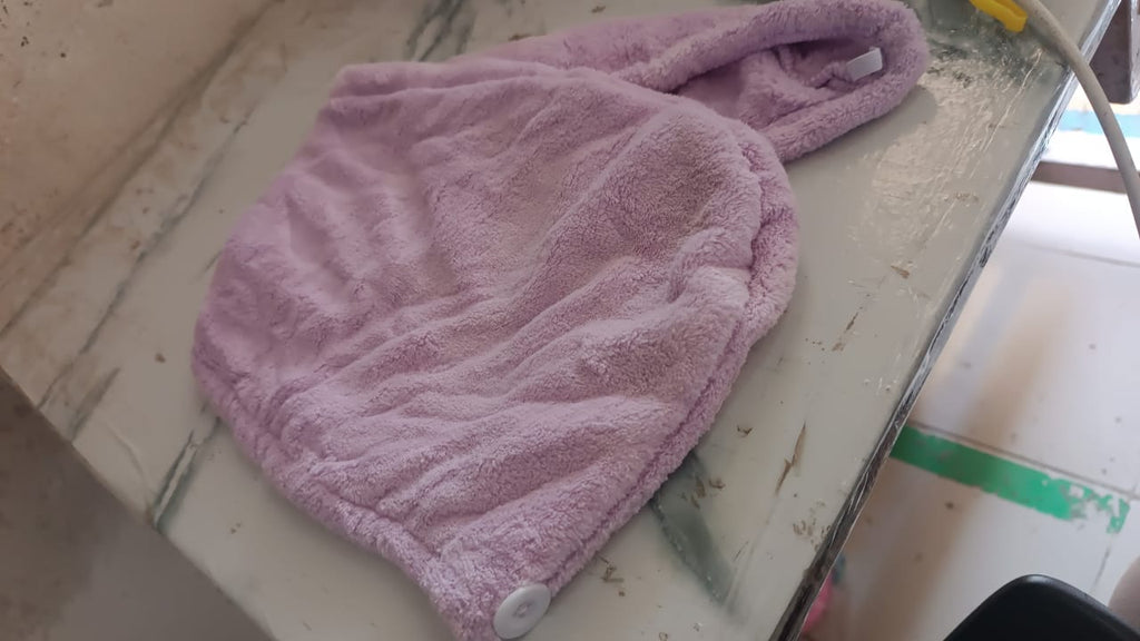 Lifestyle image of a woman comfortably wearing a microfiber hair drying wrap towel.