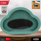 A teal cloud-shaped waterproof phone holder with a black oval pad inside, on a wooden surface.