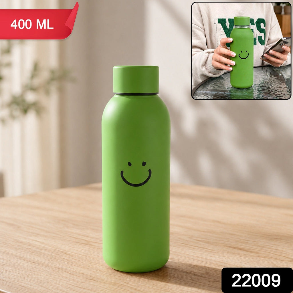 Green glass water bottle with a smiley face on a wooden table, with an inset showing a person holding a similar bottle. The