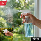 A hand holds a clear spray bottle with blue liquid, spraying water onto a windowpane, with an inset of the sprayer.